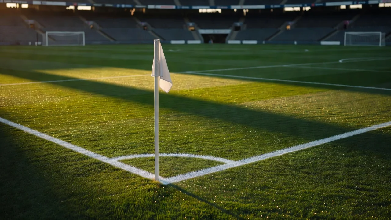 Corner flag and touchline with fresh pitch markings in morning sun